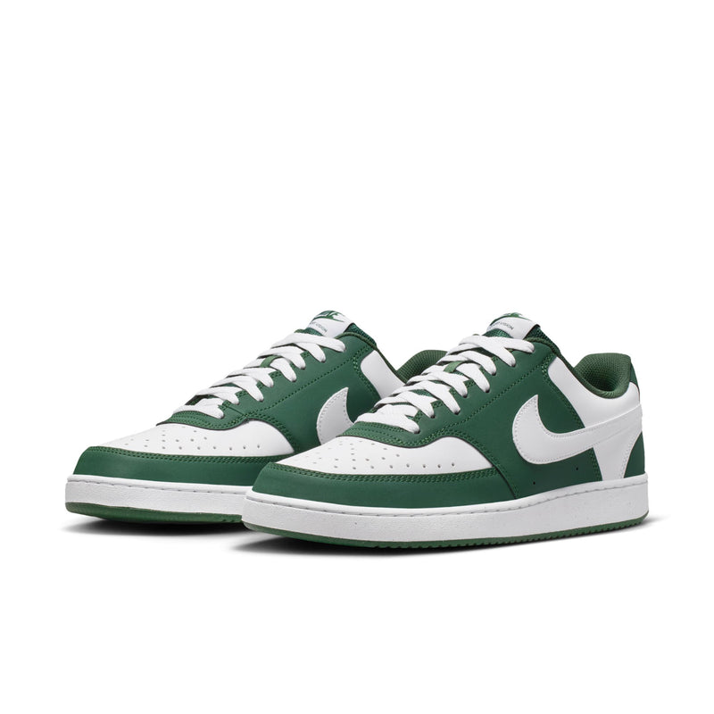 Pair of green and white low-top sneakers with white swoosh and lace-up vamps