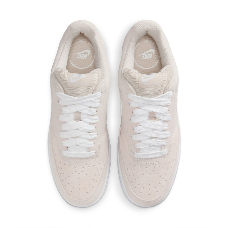 Pair of light brown low-top sneakers with white laces and perforated toe box