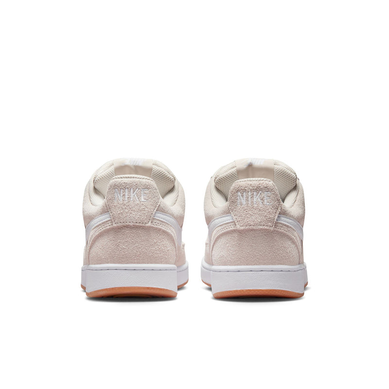 Low-top sneakers heel view in light brown suede with white midsole and gum edge