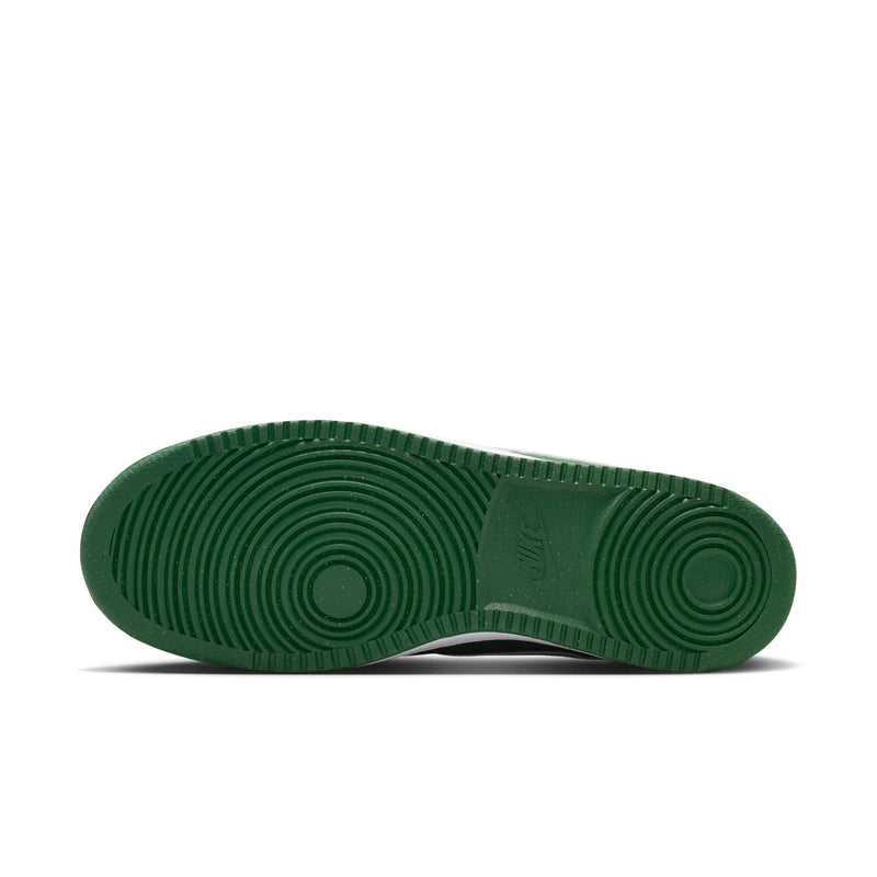 Green rubber outsole with circular traction pattern on low-top sneakers