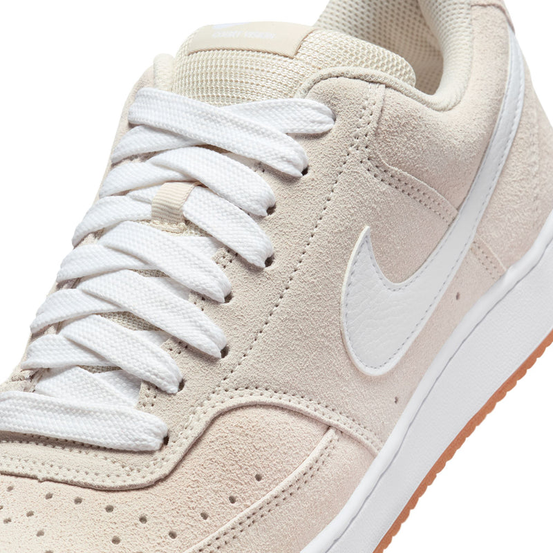Light brown suede sneaker upper with white laces and large white Nike swoosh