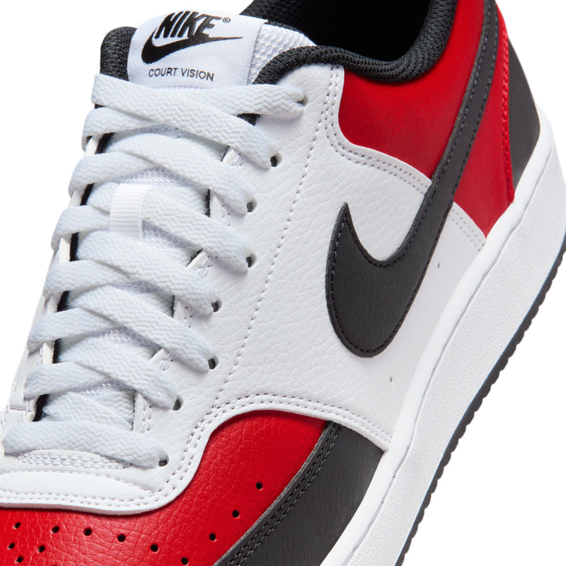 Close-up of white, red, and black low-top sneaker with white laces and Nike swoosh.