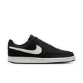 Black low-top sneakers with white swoosh and lace-up front