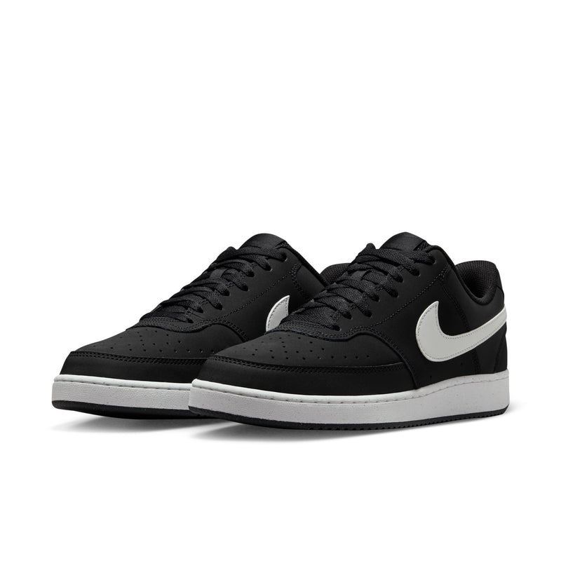 Black low-top sneakers with white midsole and swoosh, side view