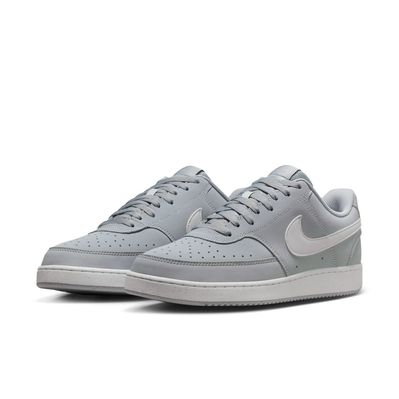 Pair of light gray low-top sneakers with white swoosh, lace-up front