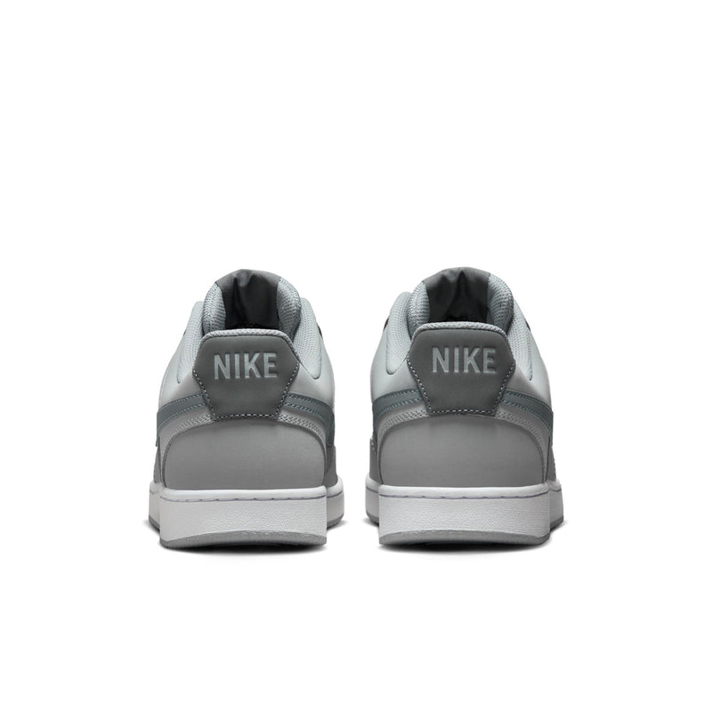 Pair of men's low-top sneakers in light smoke grey, Nike logo at the heel