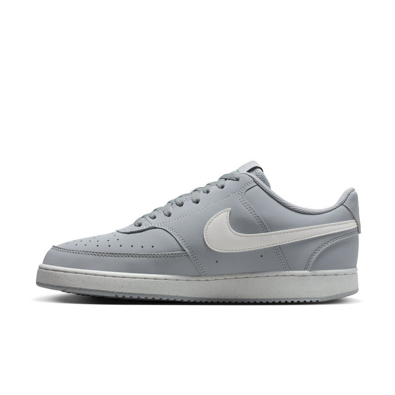 Light gray low-top sneaker with white swoosh and perforated toe box
