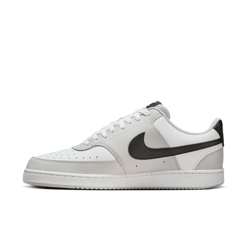 Low-top men's sneaker in white and light gray with black swoosh, lace-up front.