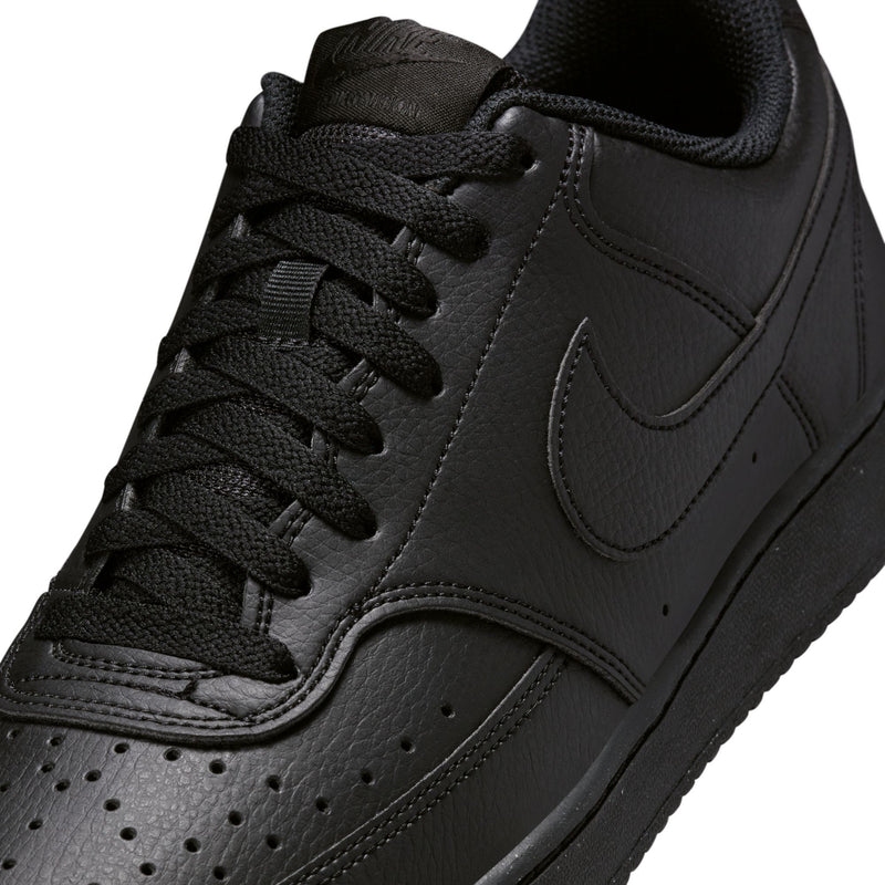 Close-up of men's black lace-up sneaker upper with swoosh and perforated toe