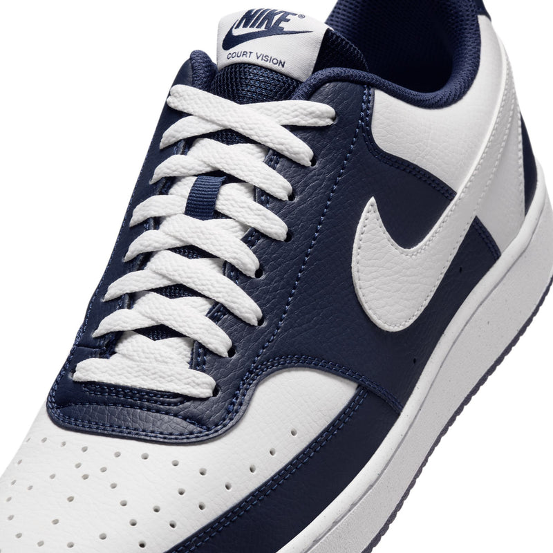 Men's sneaker upper close-up with Nike branding, navy laces, and white Swoosh.