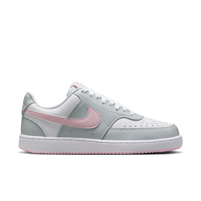 Women’s low-top sneakers in light gray with pink accent swoosh and white lace panel.