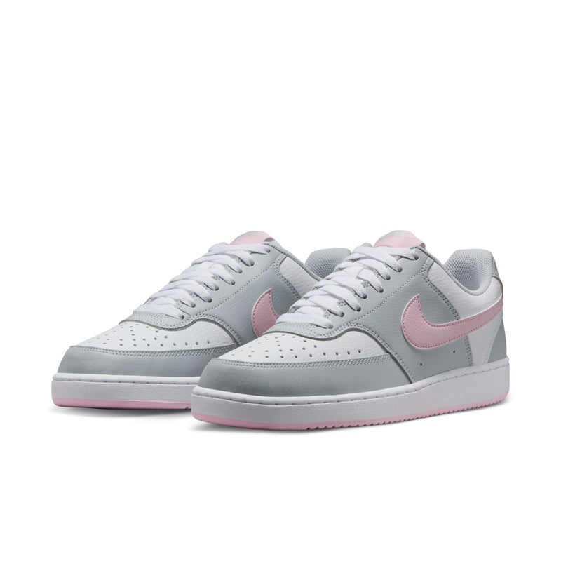 Pair of women’s low-top sneakers in light gray with pink swoosh and white outsole.