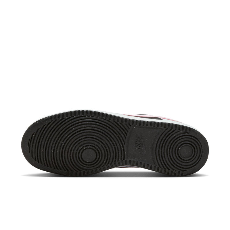 Rubber outsole of low-top sneakers with circular traction pattern and brand mark
