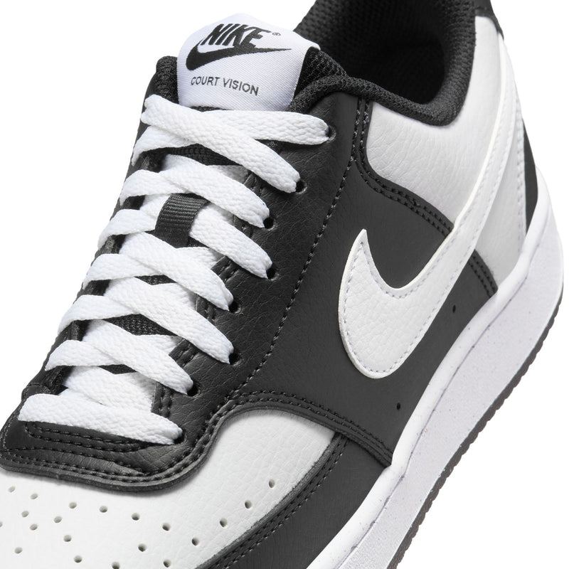 Women's sneaker close-up; black and white uppers with white laces and COURT VISION text