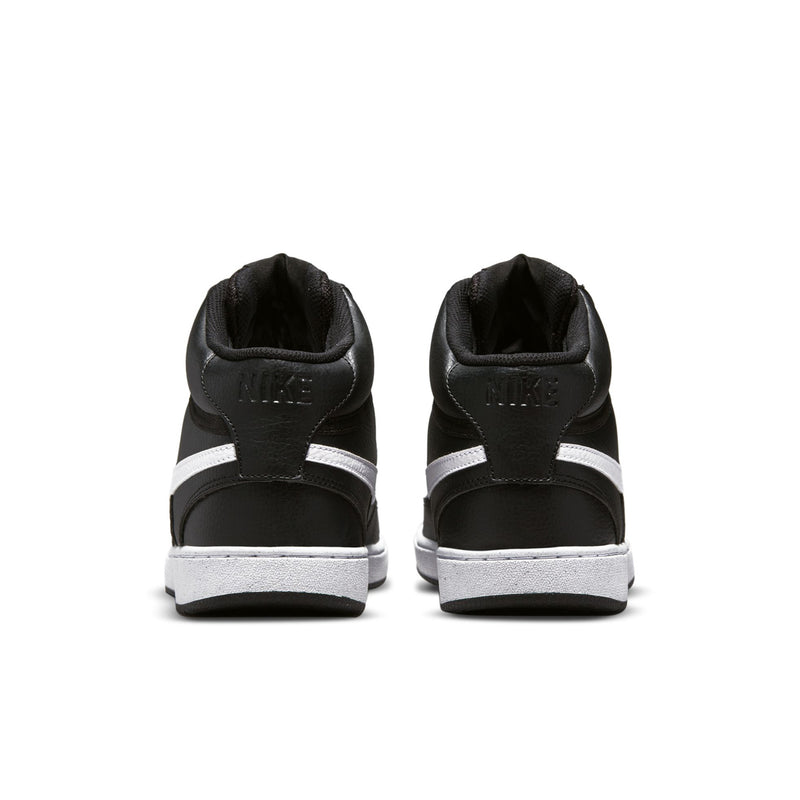 Black mid-top sneakers heel view with white stripe and white rubber sole