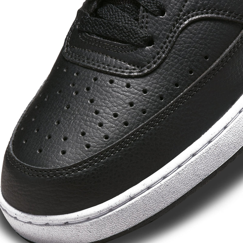 Black leather sneaker toe with perforations, laces, and white midsole