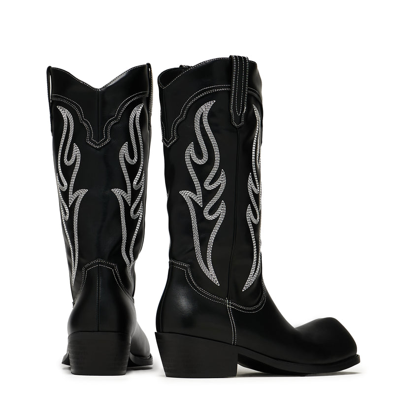 Black cowboy boots with white flame patterns on a white background