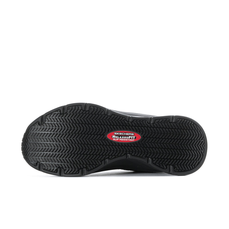 Men's black walking shoe outsole with textured traction tread and branded center patch