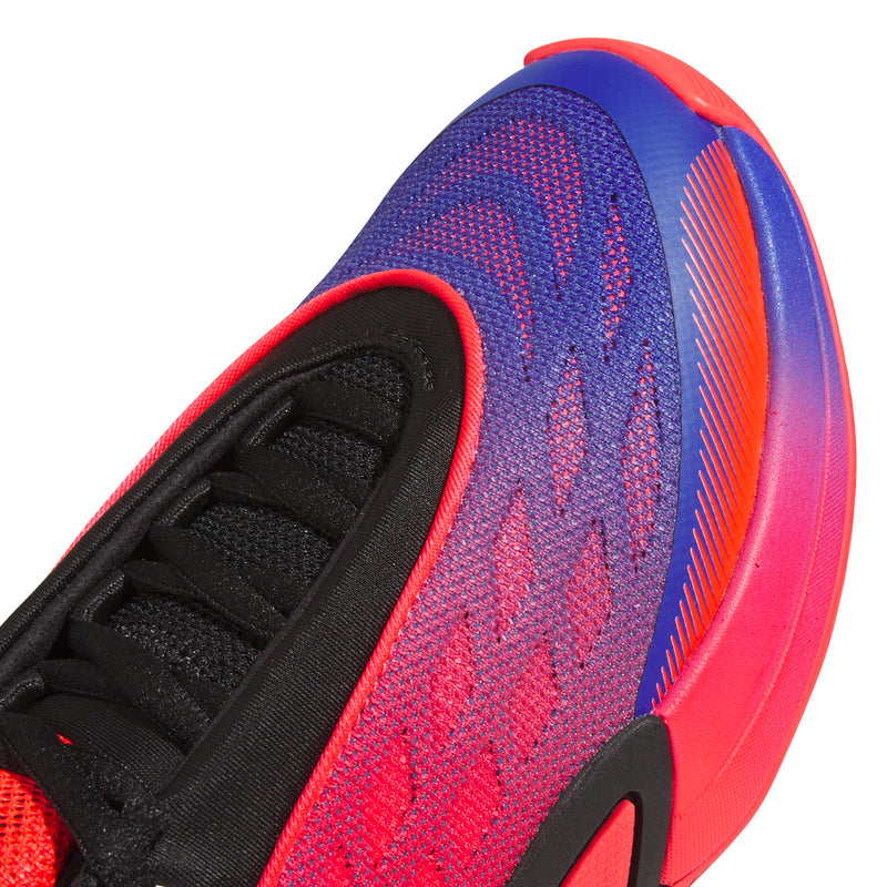 Close-up of youth shoe upper with blue textured knit and red trim near lace area