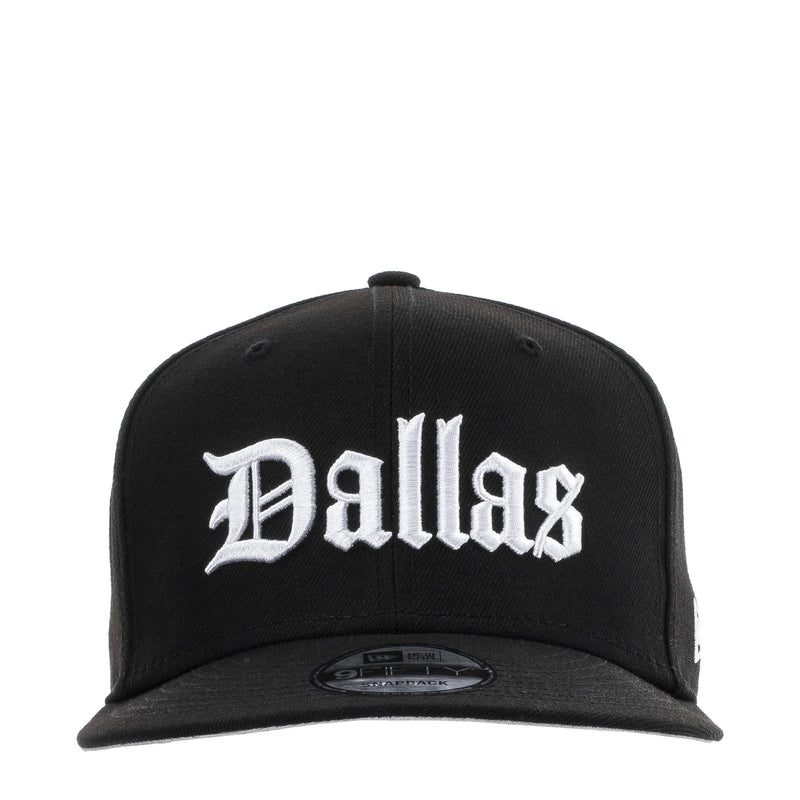 Black baseball cap with white Dallas script logo and curved brim