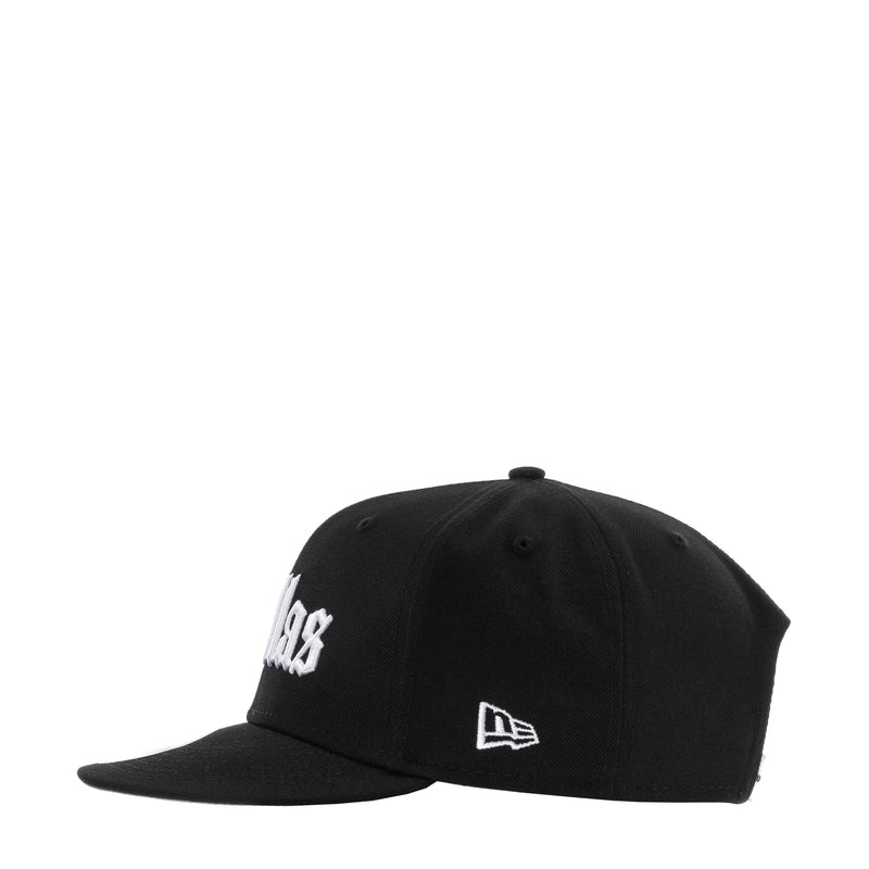 Black baseball cap with white side lettering and New Era emblem