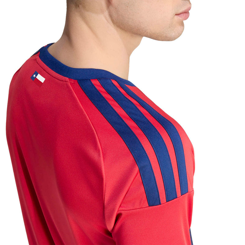 Men's red soccer jersey shoulder close-up with navy multi-stripe panel and seam details