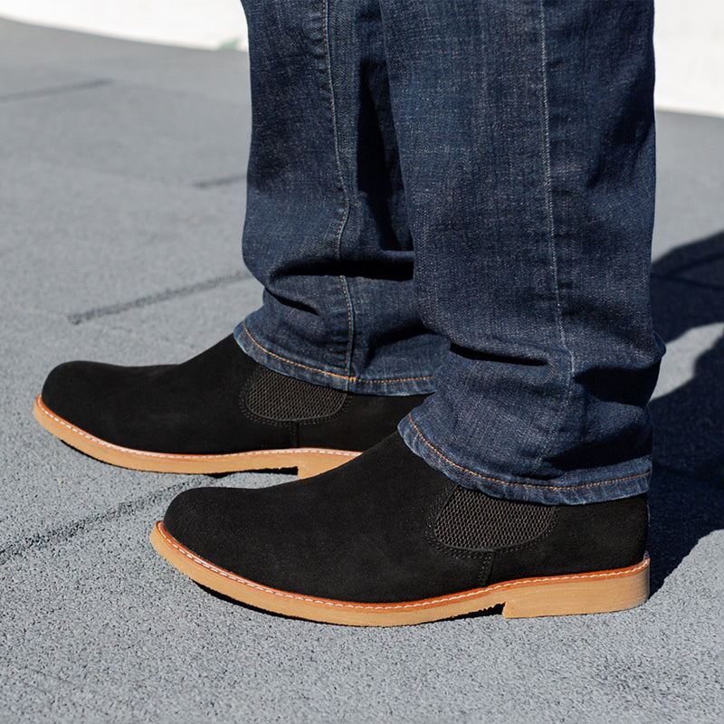 Black chelsea boots with elastic gore and tan rubber sole