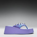 Purple sandal with decorative elements on a gray background