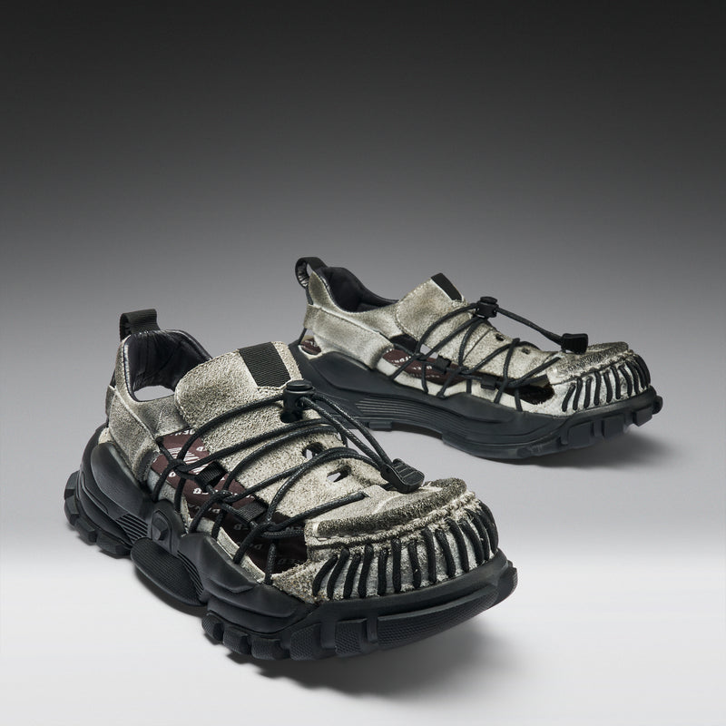 Pair of stylish shoes with black soles on a gradient background