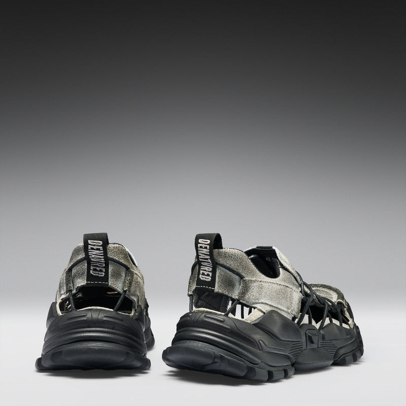 Pair of black and gray sandals on a gradient background