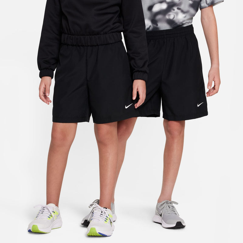 Black youth shorts with elastic waistband and side Nike logo, standing view