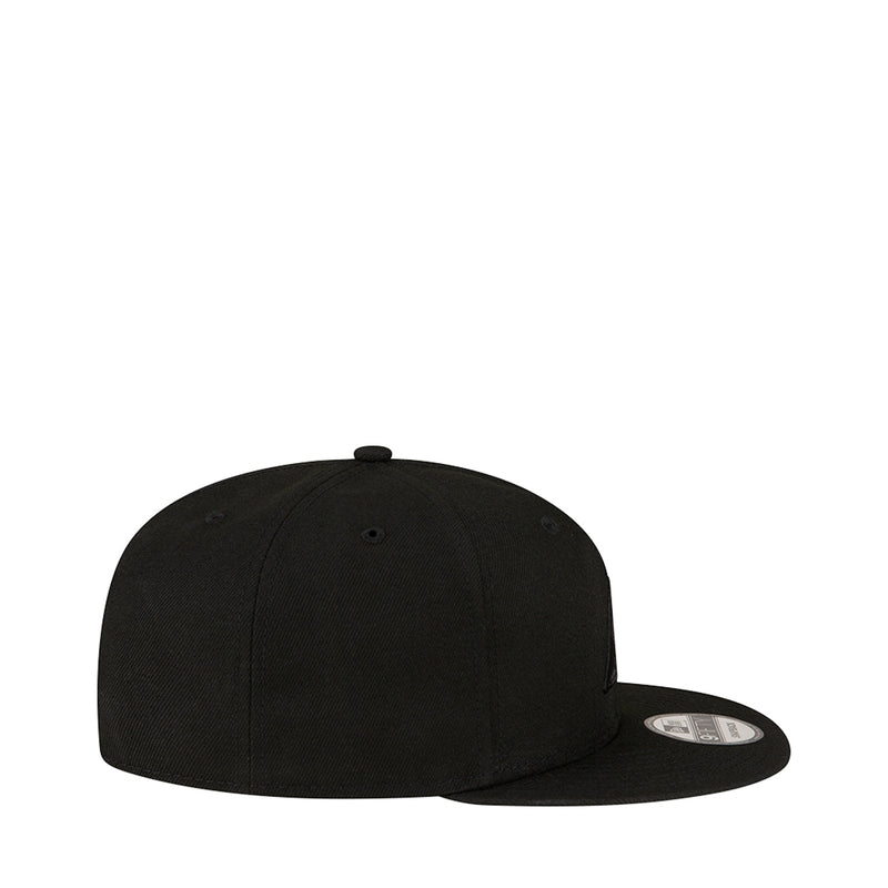Black baseball cap, side profile with curved brim and adjustable snapback.