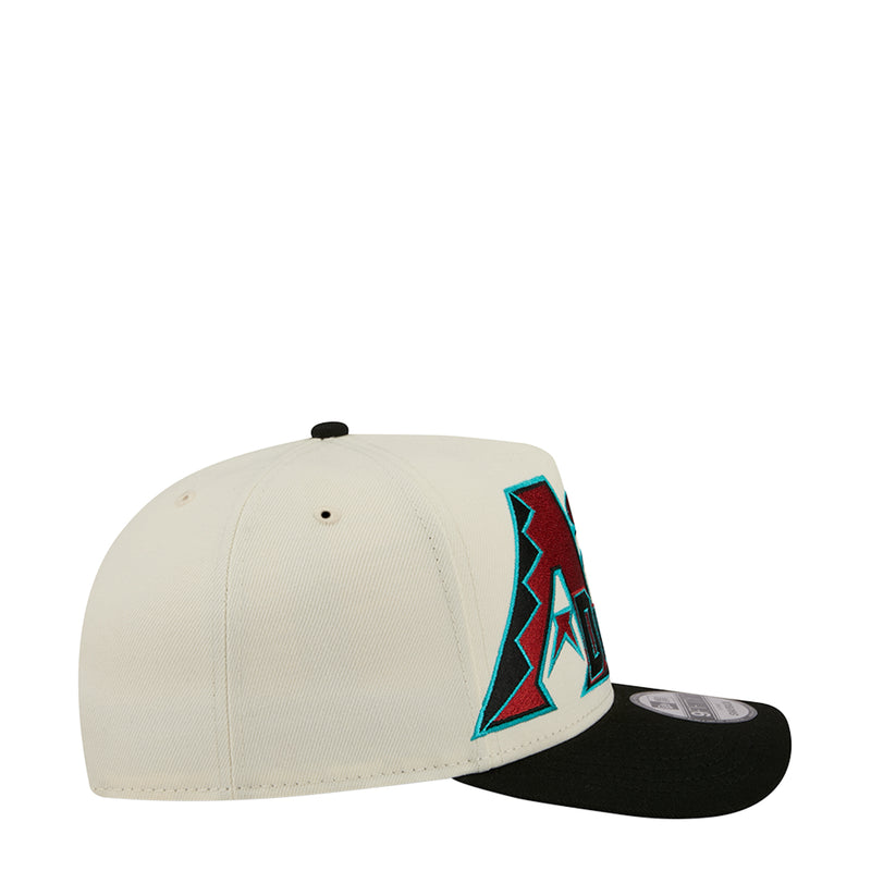 Cream and black baseball cap with large side A logo patch and black brim