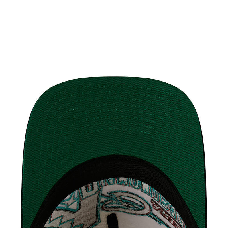 Green baseball cap close-up with black trim and partial Diamondbacks logo patch