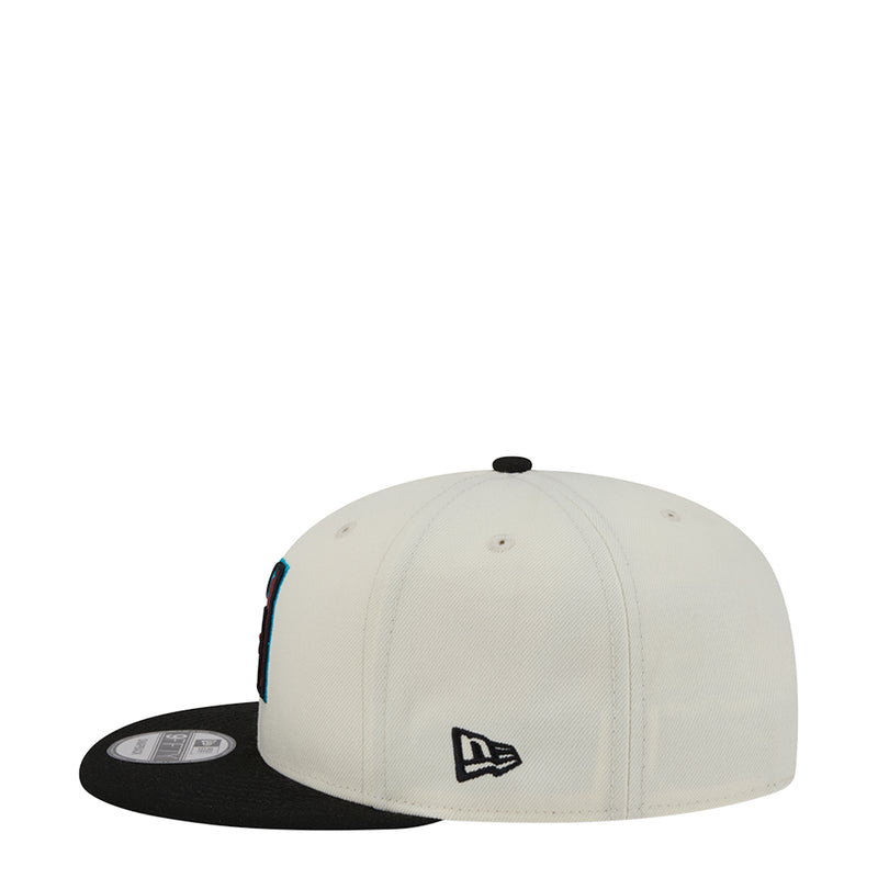 White baseball cap with black underside brim and New Era logo on side