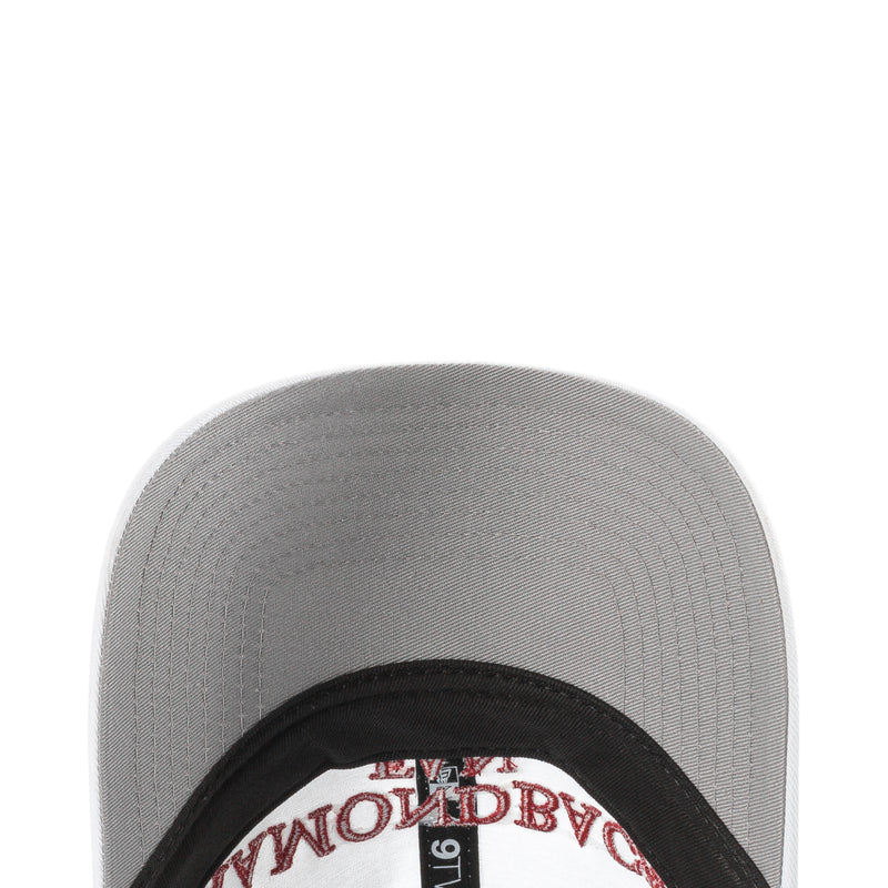 Gray cap underside with black inner trim and circular interior badge detail