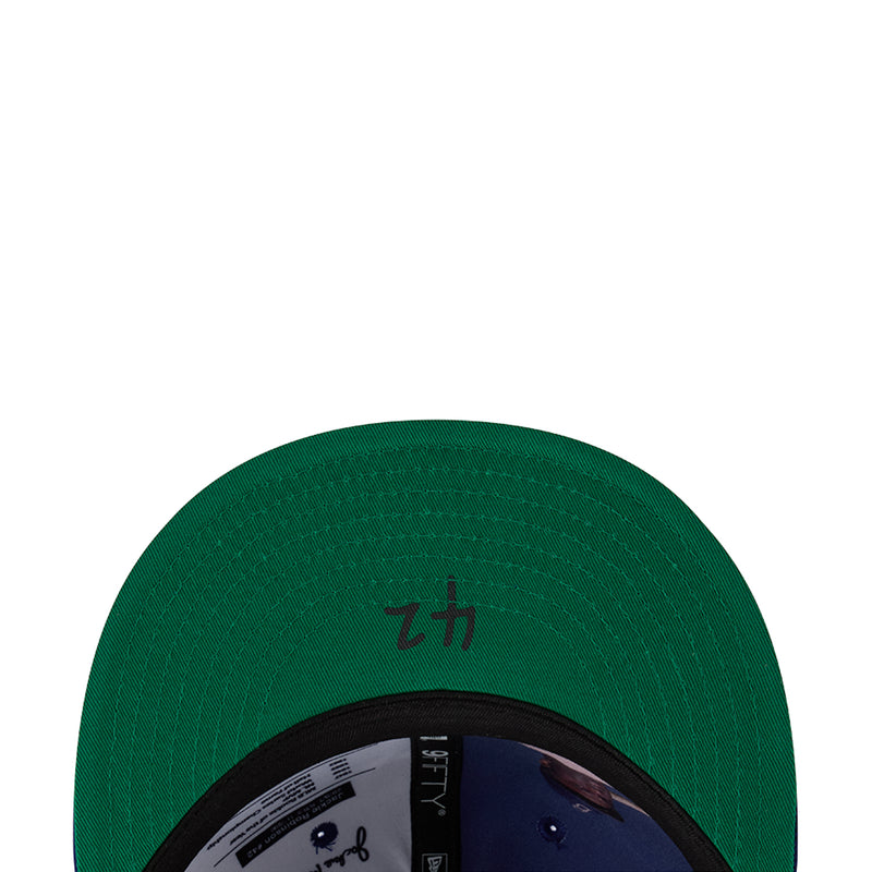 Green baseball cap with black interior ring and stitched crown pattern