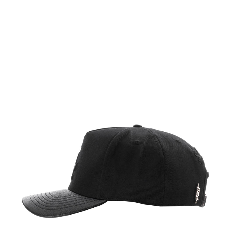 Black strapback baseball cap with side embroidery patch and curved gray brim