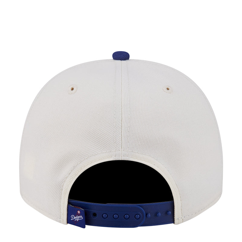 Two-tone baseball cap with white crown and blue adjustable strap inside opening