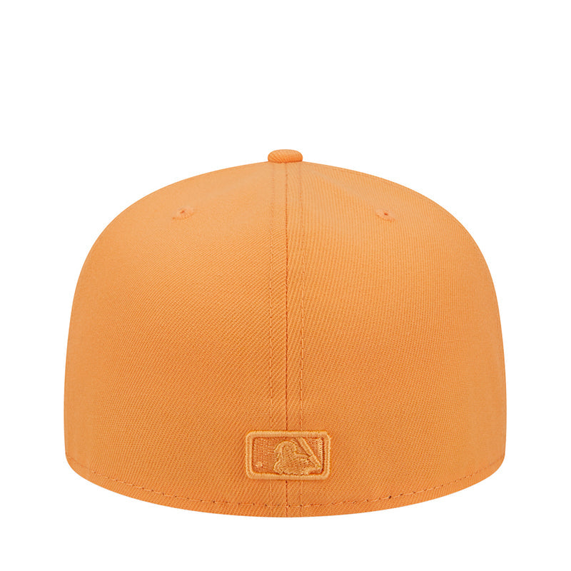 Orange baseball cap with rectangular stitched patch on crown