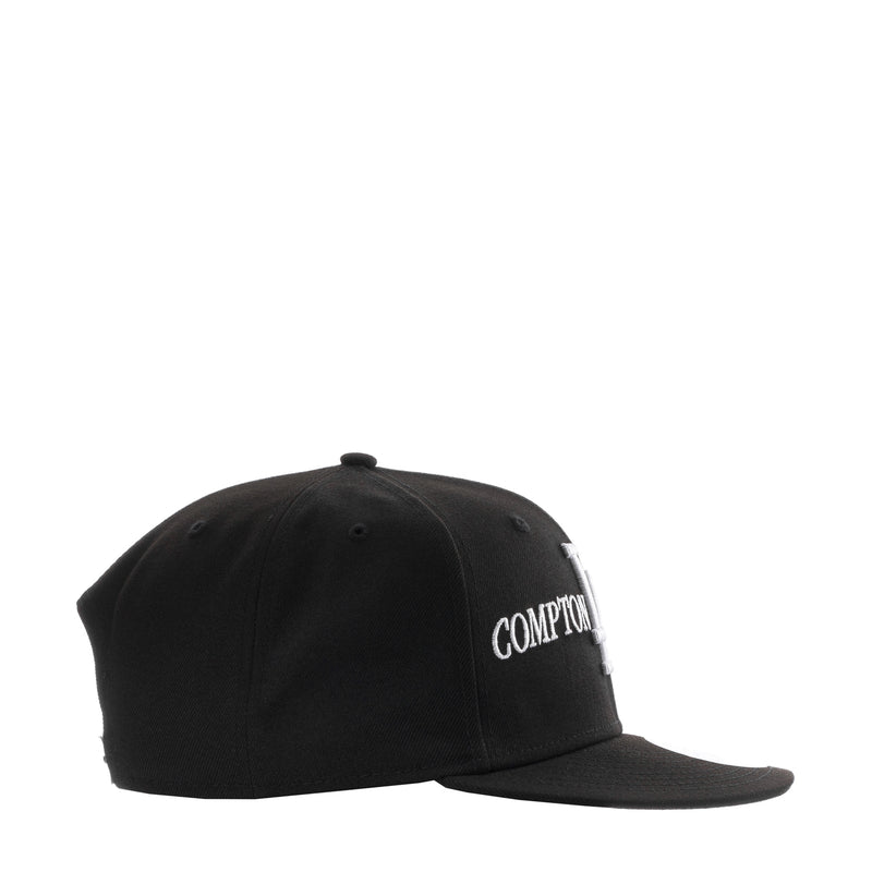 Black baseball cap with side embroidery reading “COMPTON”