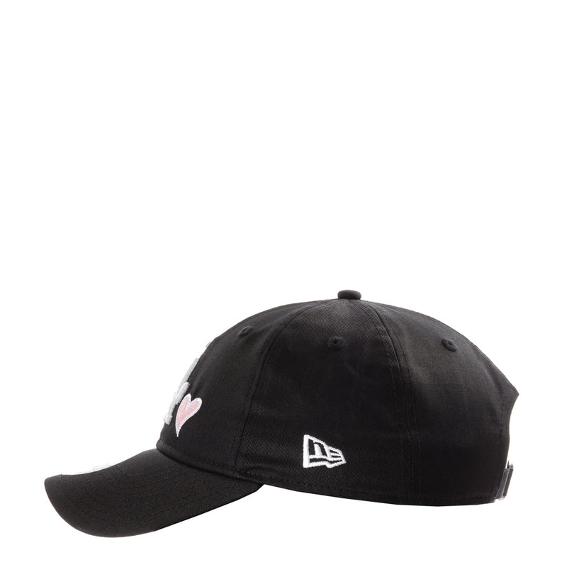 Black baseball cap with small heart emblem and New Era logo on side