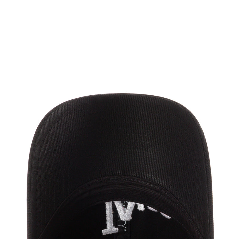 Black cap close-up of brim interior with white printed emblem