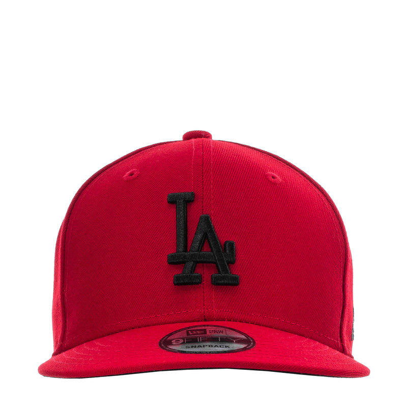 Red baseball cap with black LA logo on front panel