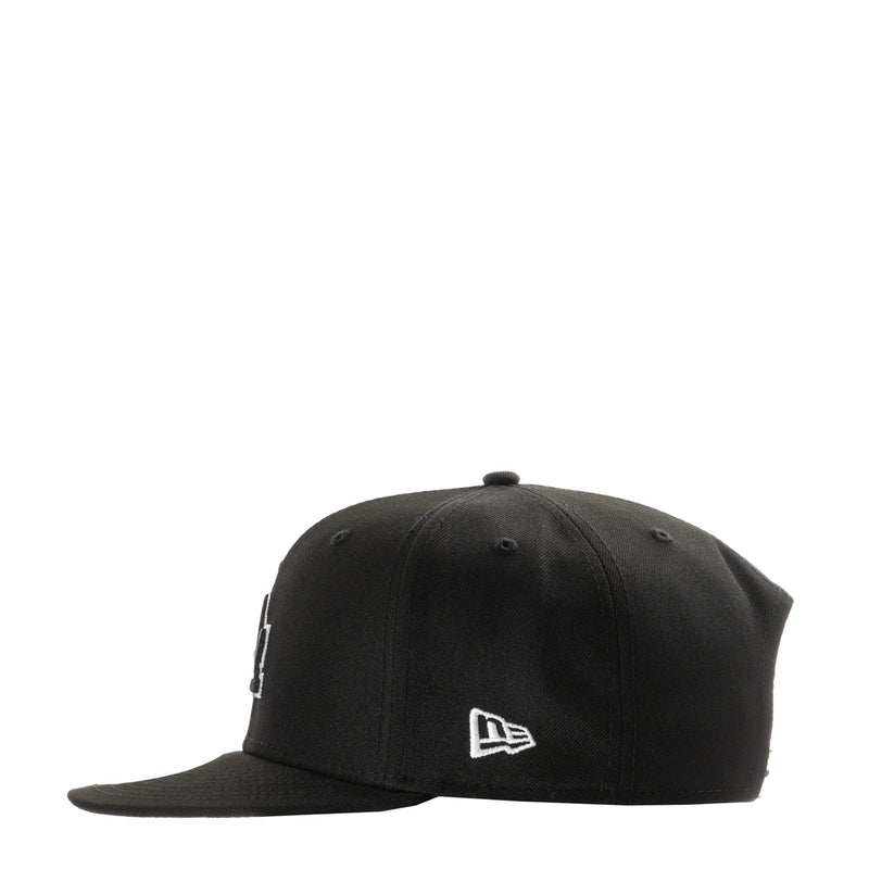 Black baseball cap with small New Era flag logo on front
