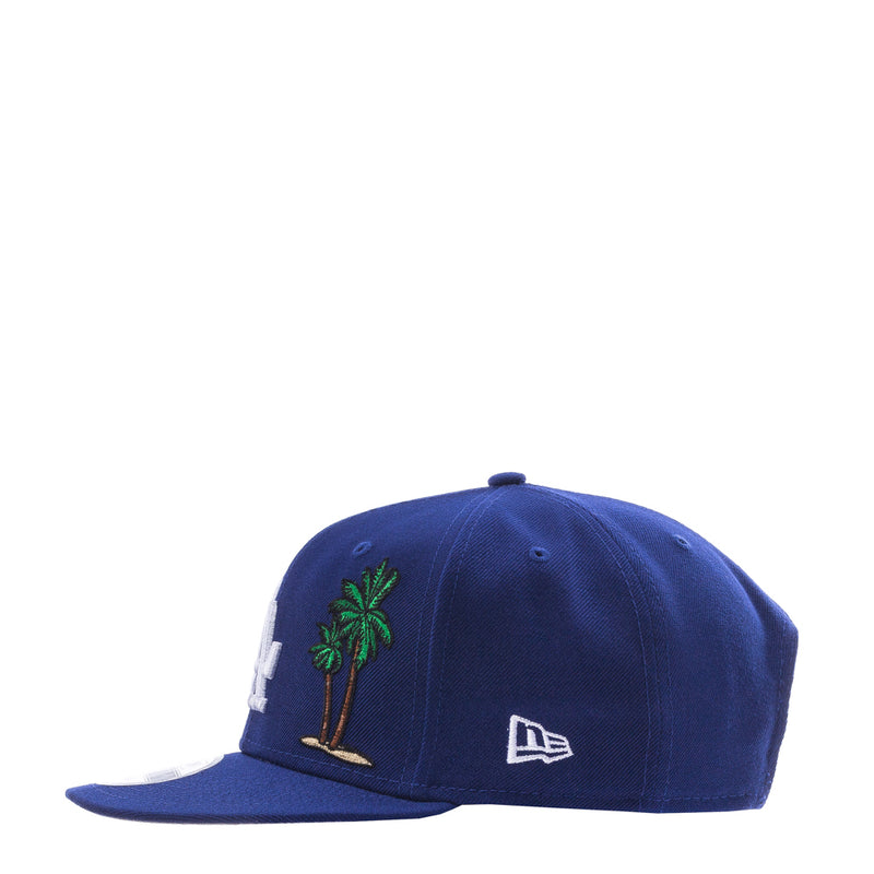 Royal blue baseball cap with green palm tree side embroidery and New Era mark