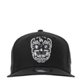 Black baseball cap with white embroidered sugar skull and LA logo at front
