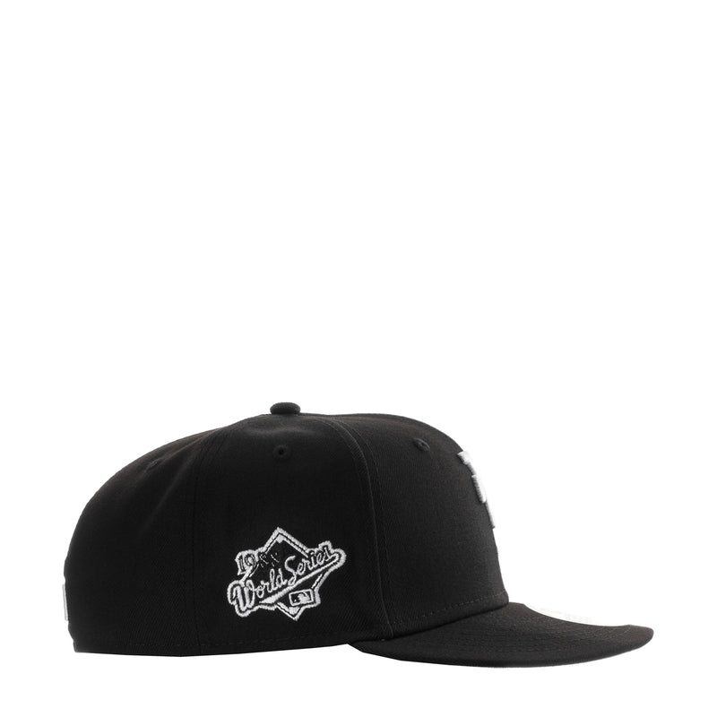Black baseball cap with white cursive Dodgers logo patch