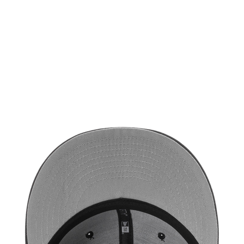 Black baseball cap brim interior with gray lining and stitching