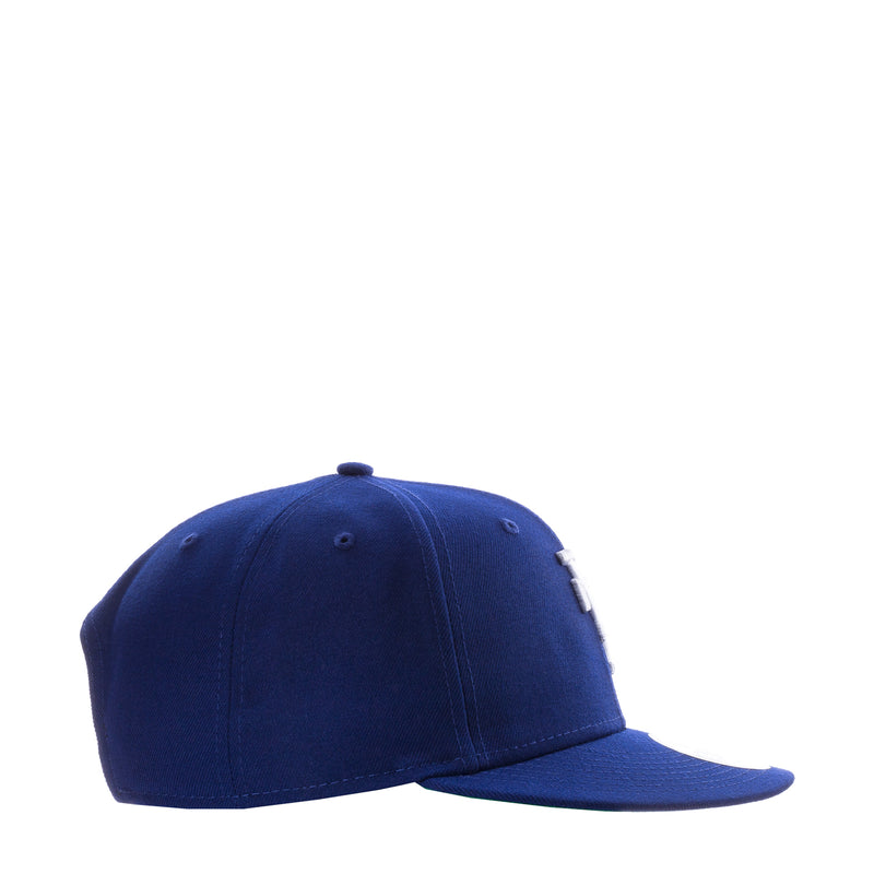 Royal blue baseball cap, side view with stitched panels and eyelets
